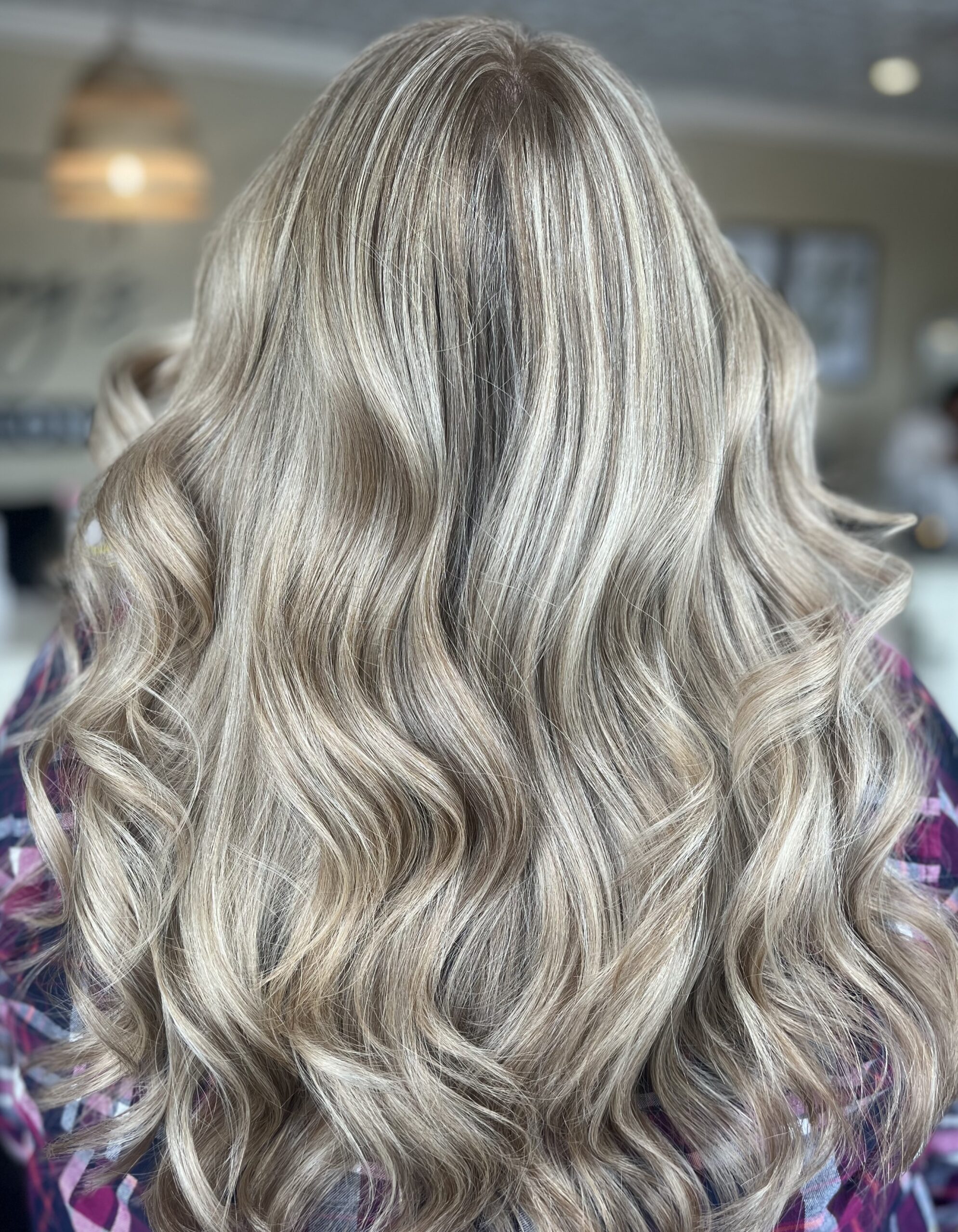 A happy client after receiving a balayage hair treatment at Jenny's Salon