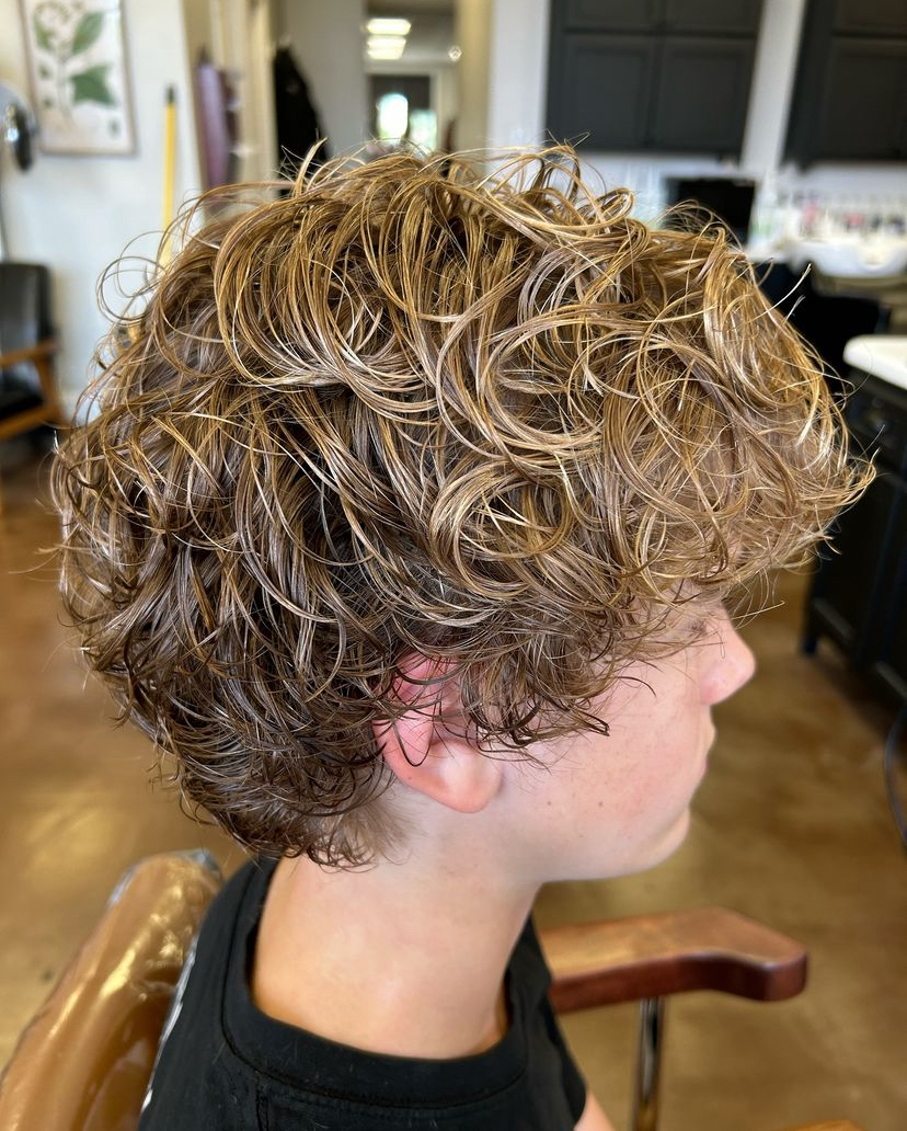 Happy client showing off his new broccoli head haircut after getting a perm at Jenny's Salon