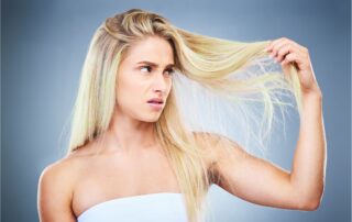 Woman with blonde hair suffering from green tint in her hair after swimming in a pool