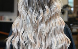 A woman showing off her beach waves summer hair from Jenny's Salon