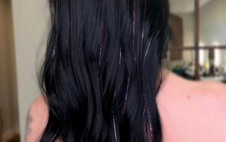 A photo of a woman showing off her hair tinsel from Jenny's Salon in Mechanicsburg, PA