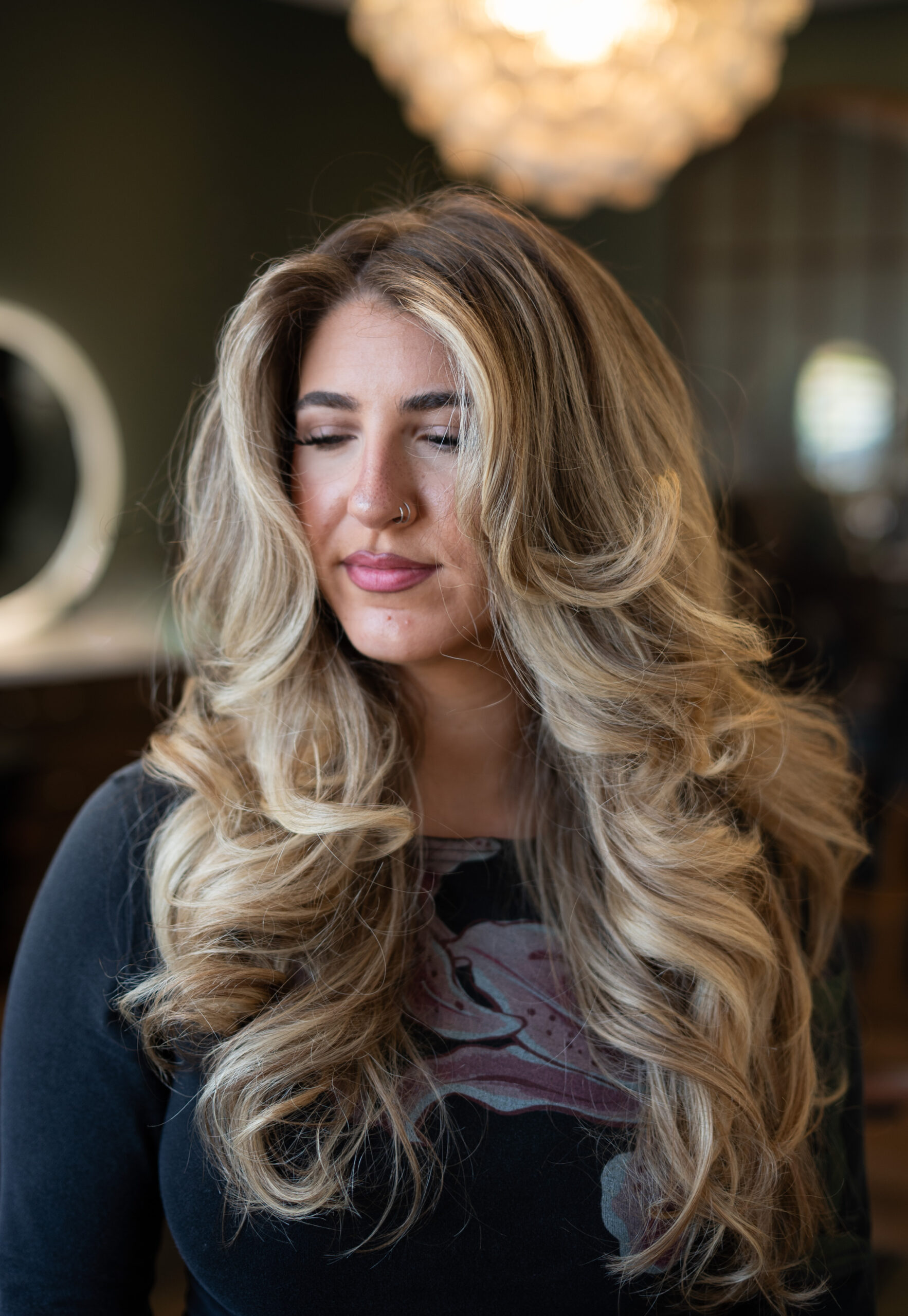 A photo of a female client showing off her Soft Polished Blowout hair that she got at Jenny's Salon in Mechanicburg, PA